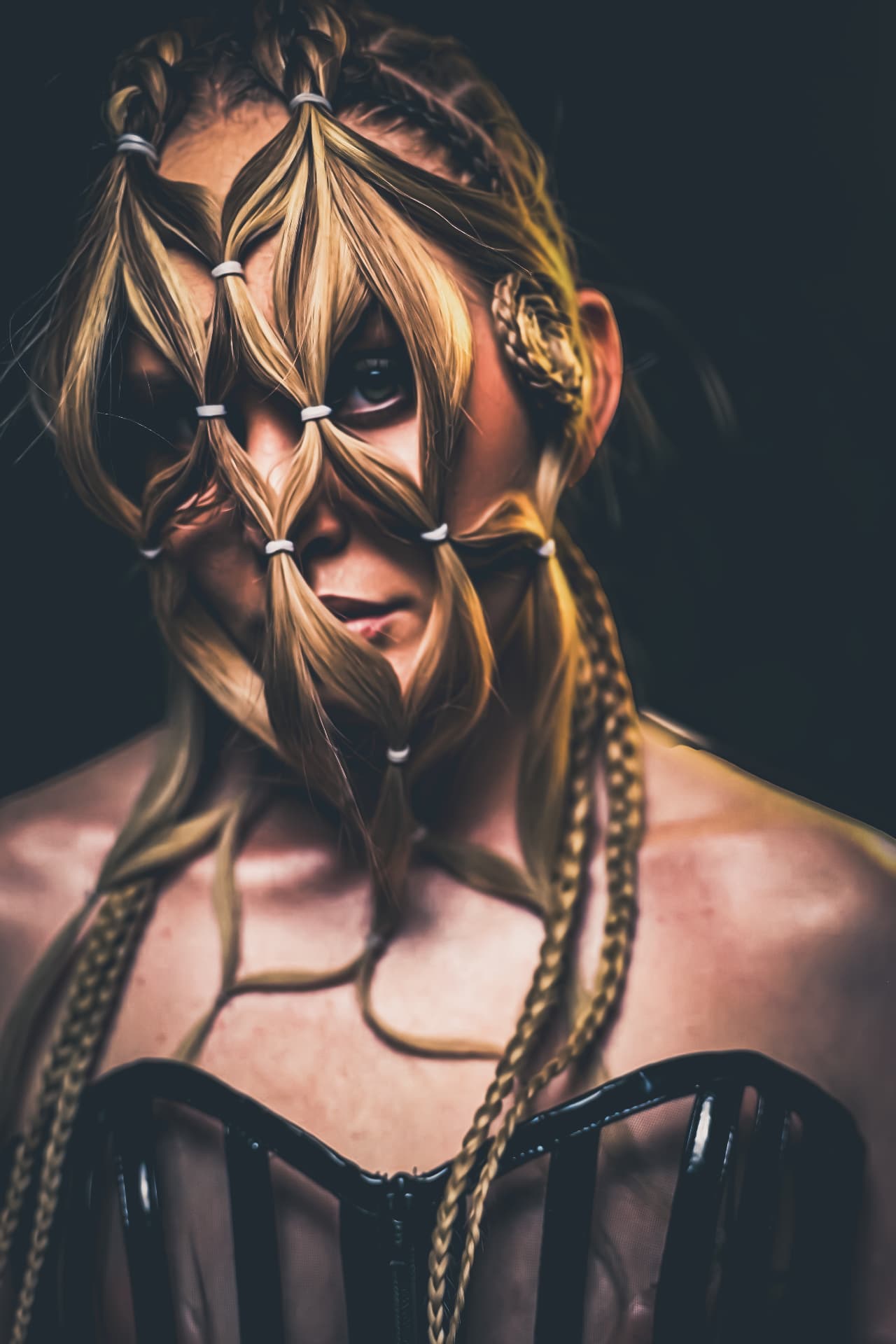 Editorial hair artwork with sectioned strands banded across the face