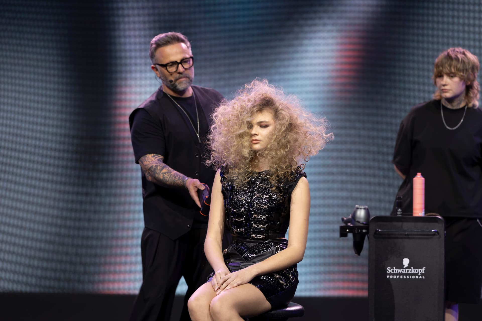 Models presenting completed looks on stage